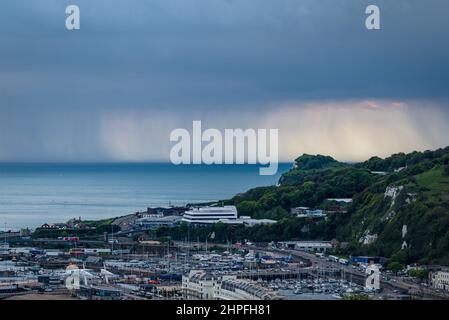 A view of heavy rain across the English Channel with the Port of Dover in the foreground as seen from Dover Castle, Dover, Kent, England, UK Stock Photo