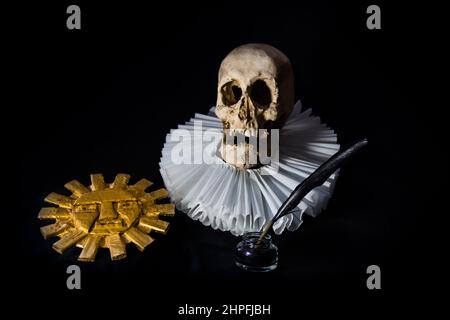 Books with a human skull, a ruff and the Inca sun, symbols of universal literature. Day of the book Stock Photo