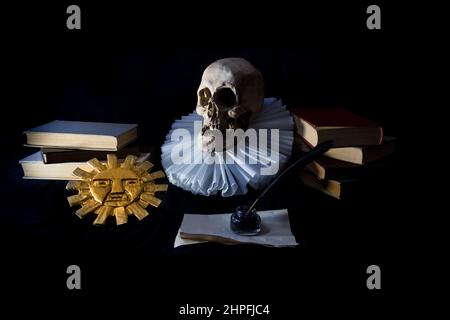 On a black background books with a human skull, a ruff and the Inca sun, symbols of universal literature. Day of the book Stock Photo