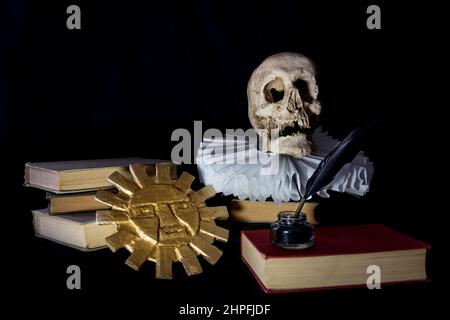 Books with a human skull, a ruff and the Inca sun, symbols of universal literature. Day of the book Stock Photo