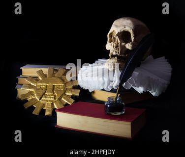 Books with a human skull, a ruff and the Inca sun, symbols of universal literature. Day of the book Stock Photo