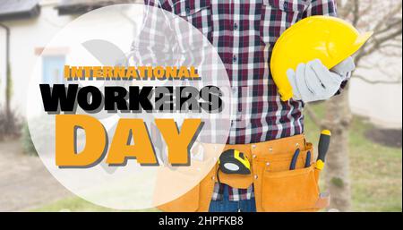 Digital composite of international workers day text on midsection of caucasian construction man Stock Photo