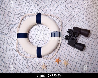Grid, circle, binoculars and starfish on a wooden background Stock Photo