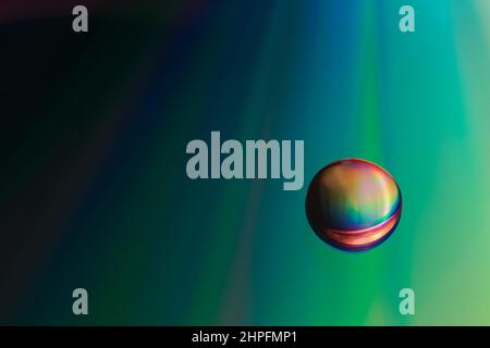 Shiny raibow colored water drops on the old compact CD disc, design for background Stock Photo