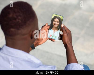 Young African American Man Making Video Call With Smartphone To His Girflriend Stock Photo