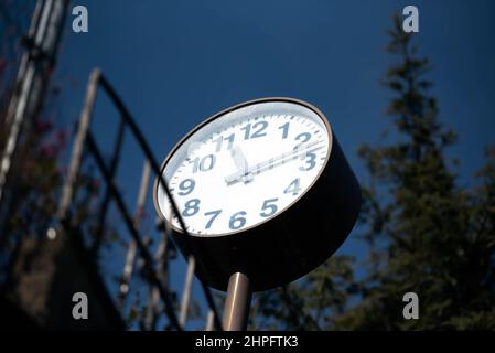 A big street clock bottom view from below Stock Photo