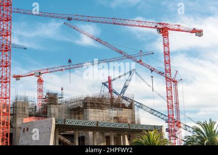 Building red crane and building under construction against blue sky Stock Photo