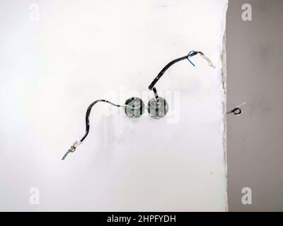 Apartment renovation concept. New wiring for socket and switch in the wall. Stock Photo
