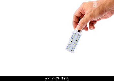 Human hand holding LED light bulb isolated on white background. Stock Photo