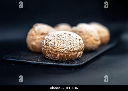 Appetizing Shu cakes on a black background. Stock Photo