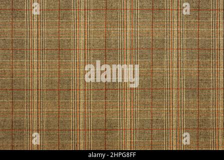 Checkered fabric in yellow or brown. Background from checkered fabric. Material with straight lines and squares Stock Photo