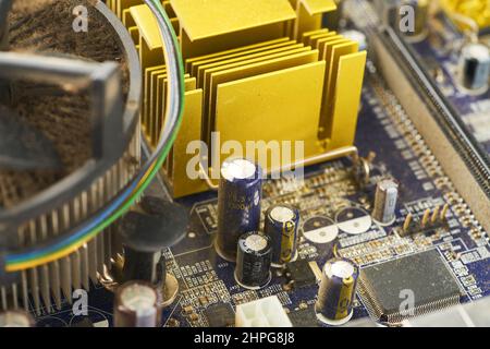 Old computer system unit with spider web and dust inside. Stock Photo