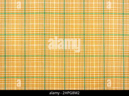 Checkered fabric in yellow or brown. Background from checkered fabric. Material with straight lines and squares Stock Photo