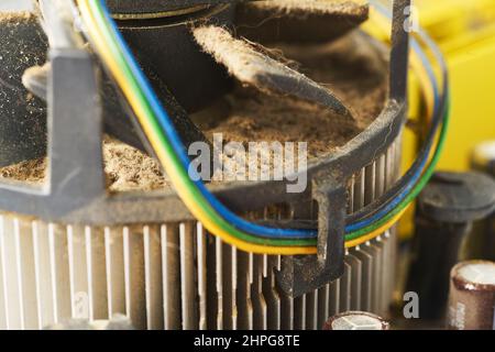 Old computer system unit with spider web and dust inside. Stock Photo