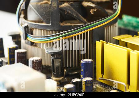 Old computer system unit with spider web and dust inside. Stock Photo