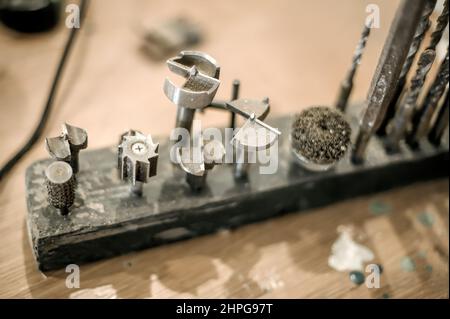 Close up of tools drill bit on wooden work table Stock Photo