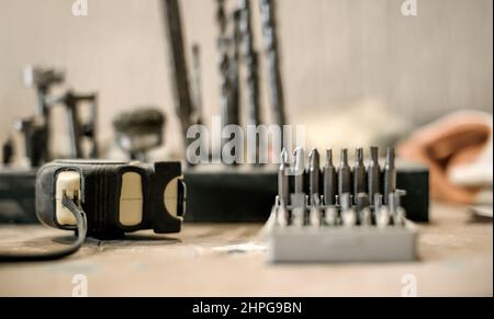 Close up of tools drill bit on wooden work table Stock Photo