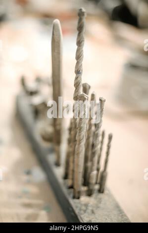 Close up of tools drill bit on wooden work table Stock Photo