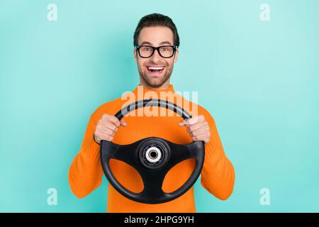 Photo of astonished satisfied person hands hold wheel look camera isolated on turquoise color background Stock Photo