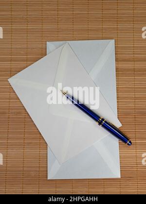 Blue ballpoint pen and two envelopes Stock Photo