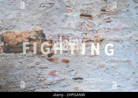 The fighting word on the wall. Business Concept image. Expectation Prediction Hope Strategy Planning Concept. Stock Photo