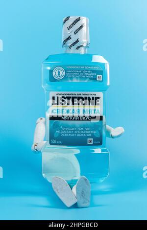Tyumen, Russia-February 06, 2022: Listerine on blue background. Listerine is a brand of antiseptic mouthwash product. Vertical photo Stock Photo