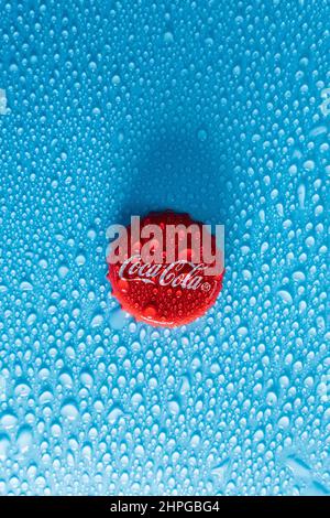 Tyumen, Russia-January 19, 2022: Coca Cola red cap of glass bottle. Droplets of water copy space Stock Photo