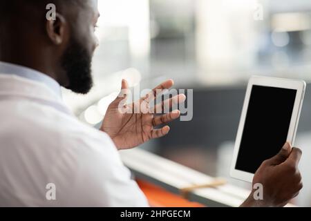 Black scientist using digital tablet with empty screen, mockup Stock Photo