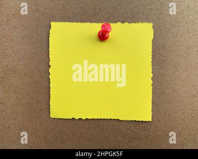 Top view of torn yellow notepad waiting to be filled. Stock Photo