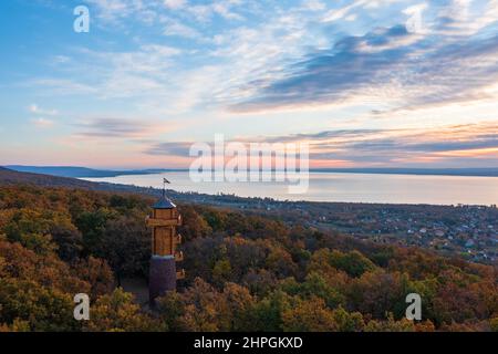 Aerial view about the freshly renovated lookout tower at Révfülöp. Lake Balaton and cloudy autumn sunrise at the background. Stock Photo