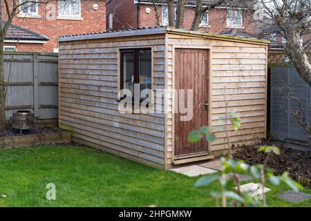 Insulated garden shed used as an outdoor office / summerhouse for WFH (working from home) in Worcester, UK. Concept: garden studio, back yard studio Stock Photo