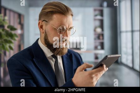 Businessman at office with smartphone Stock Photo