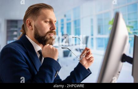 Man working on pc at office Stock Photo