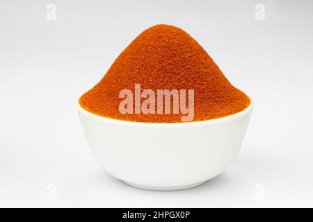 Red chilly powder ,Indian spice ;arranged in a white bowl  with white texture or background Stock Photo