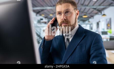 Man talking on mobile at office Stock Photo