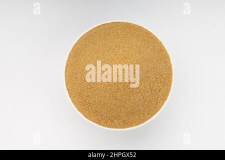 Coriander powder ,indian spice ; main ingrediant for indian dishes ,arranged in a white bowl on a white textured background,top view Stock Photo