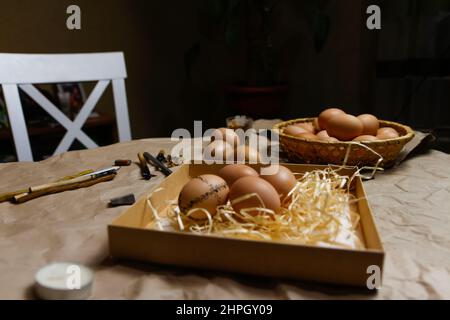 Tools for decorating Paschal eggs, Pysankas. Workplace. Rustic background. Collection of eggs. Homemade pen for drawing eggs. Preparation for holiday. Stock Photo