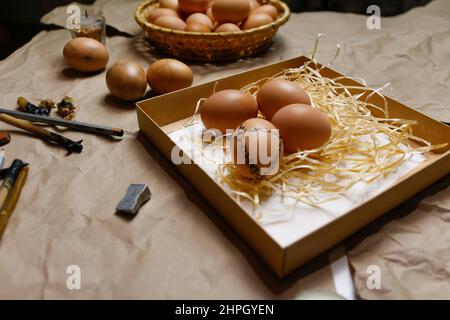 Tools for decorating Paschal eggs, Pysankas. Workplace. Rustic background. Collection of eggs. Homemade pen for drawing eggs. Preparation for holiday. Stock Photo