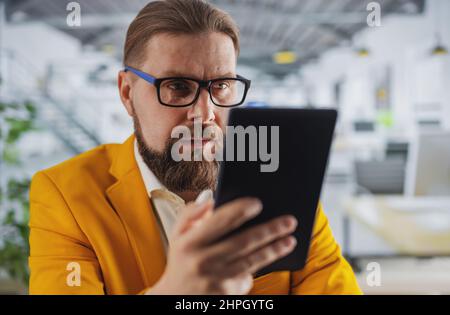 Businessman at office with tablet Stock Photo