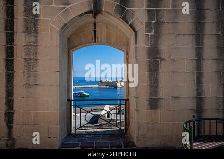 View of Mediterranean sea from window in city wall in Valletta, Malta. View from lower barrakka gardens. Stock Photo