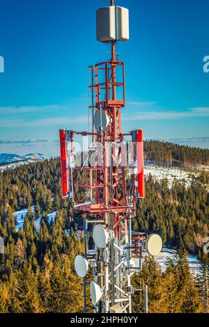 Telecommunication tower with antennas in mountain landscape. Stock Photo