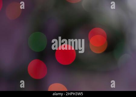 Abstract blur bokeh background. Defocused blurred red, orange, yellow and green color lights on dark background Stock Photo