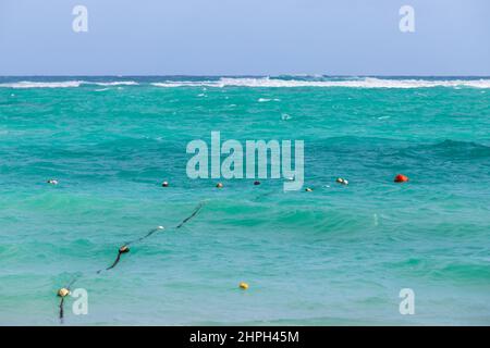 Atlantic ocean, shore water with buoys and ropes fencing, Dominican republic. Bavaro beach Stock Photo