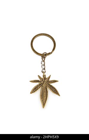 golden colored key ring marijuana, isolated on white background Stock Photo