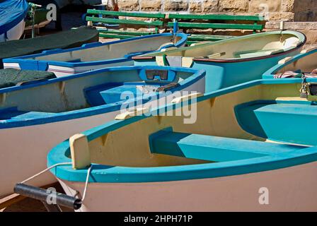 Small rowing boats for hire in a harbor on the island Malta. Stock Photo