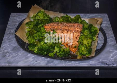 Close up view of oven baked pink salmon and broccoli. Healthy food concept. Sweden. Stock Photo