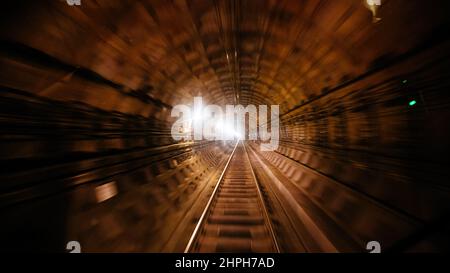 Metro subway tunnel with motion blur, view inside locomotive. Stock Photo