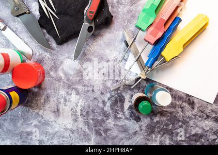 Various sharpening stones and knives. Preparation for tool sharpening. Knives and whetstones. Flat lay. Stock Photo