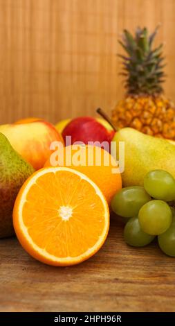 Spring or Summer concept. Many kinds of fruit. Vertical photo, can use for summer or food content background. Orange, apple, pineapple Stock Photo