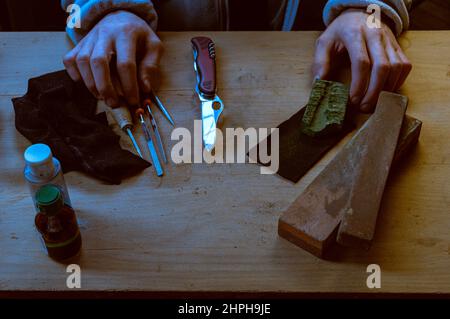 An old whetstone for sharpening knives. Grinding wheel on an old tripod.  Season of the autumn Stock Photo - Alamy